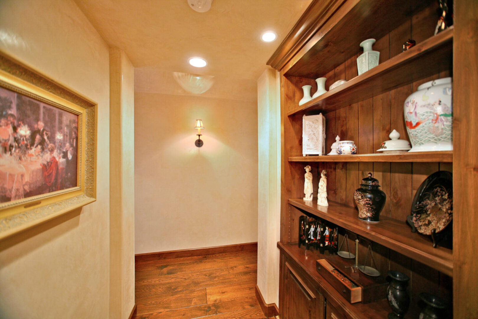 A hallway with shelves and cabinets in it