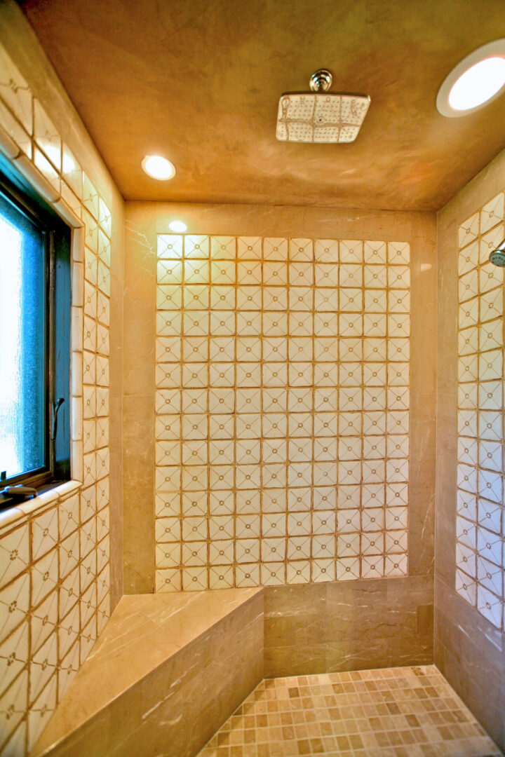 A bathroom with tiled walls and a window.