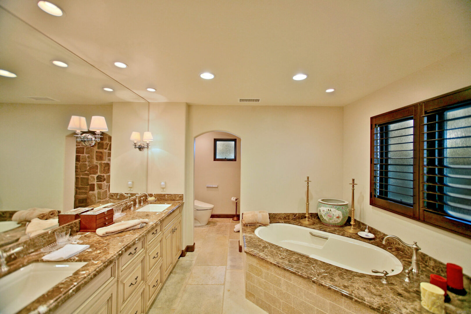 A bathroom with two sinks and a large tub.