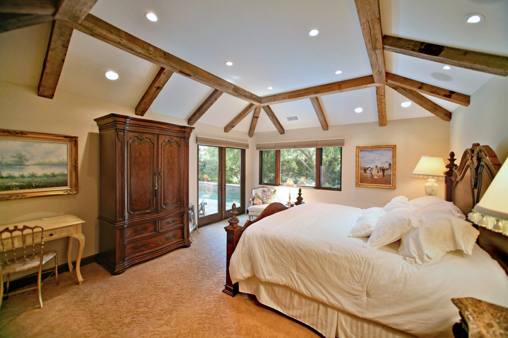 A bedroom with a large bed and wooden furniture.