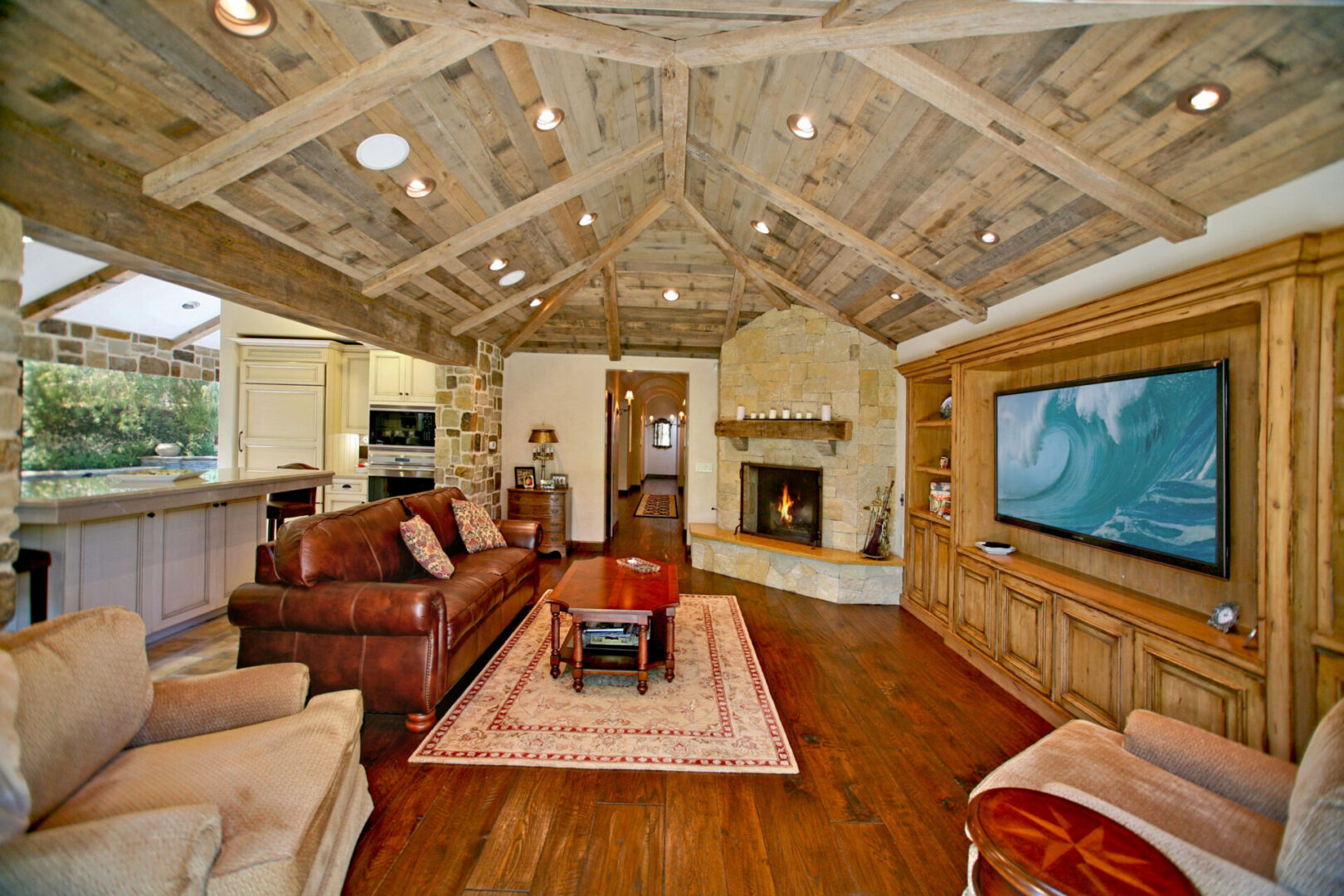 A living room with a couch, chair and television.