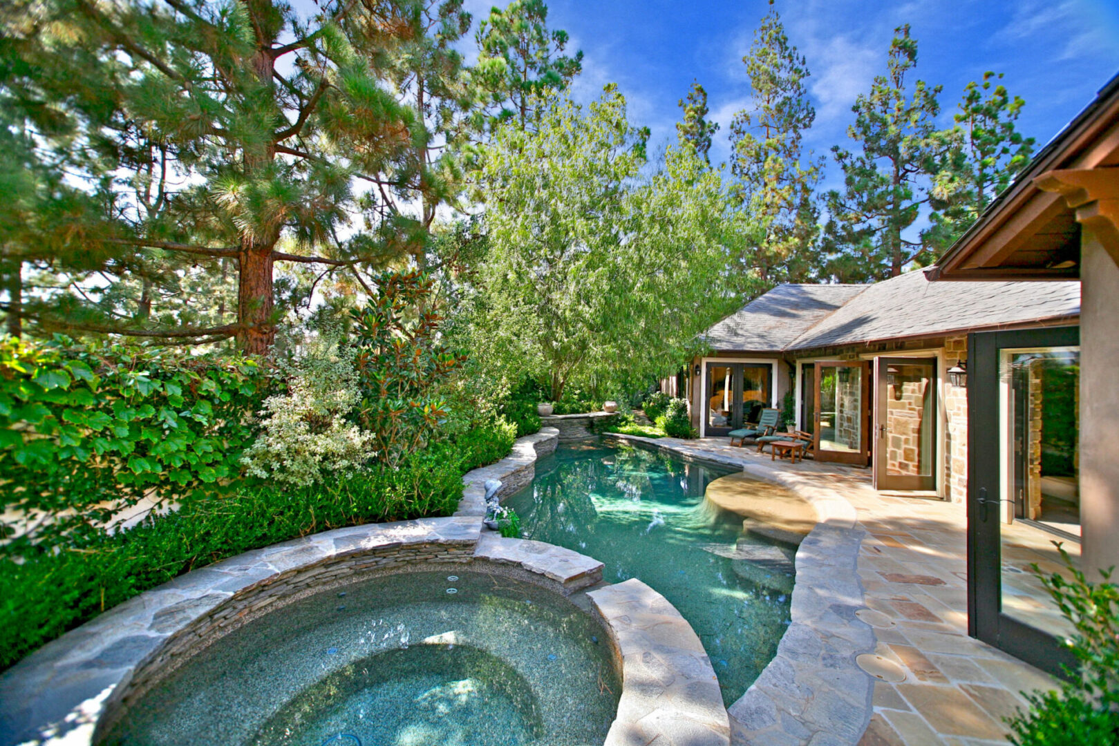 A pool with a hot tub in the middle of it