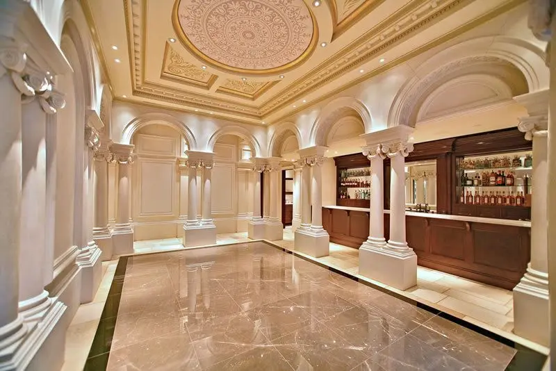 A large room with pillars and marble floors.