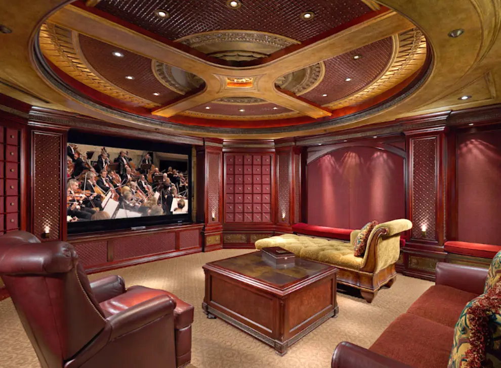 A living room with a large screen tv and couches