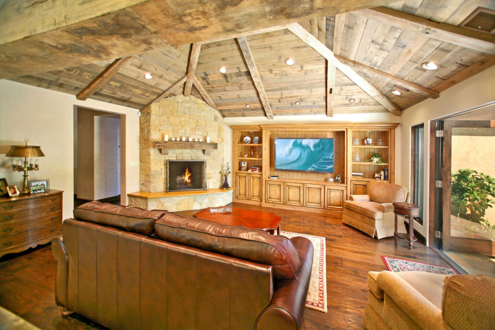 A living room with a fireplace and a television.