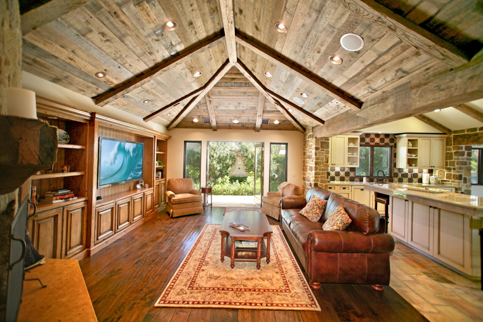 A living room with wood floors and vaulted ceilings.