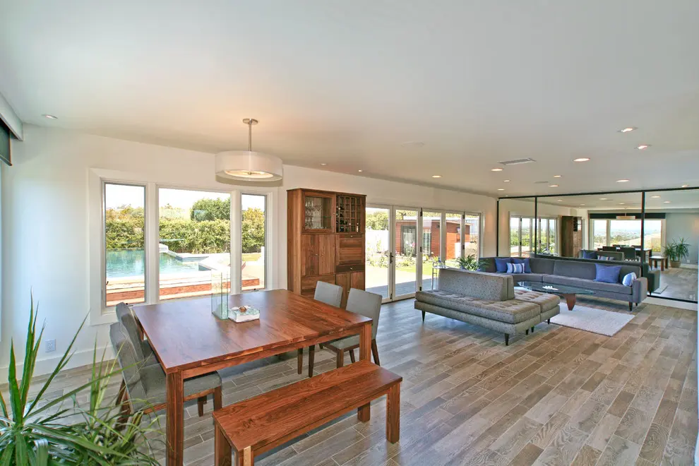 A large open living room with wooden floors and furniture.