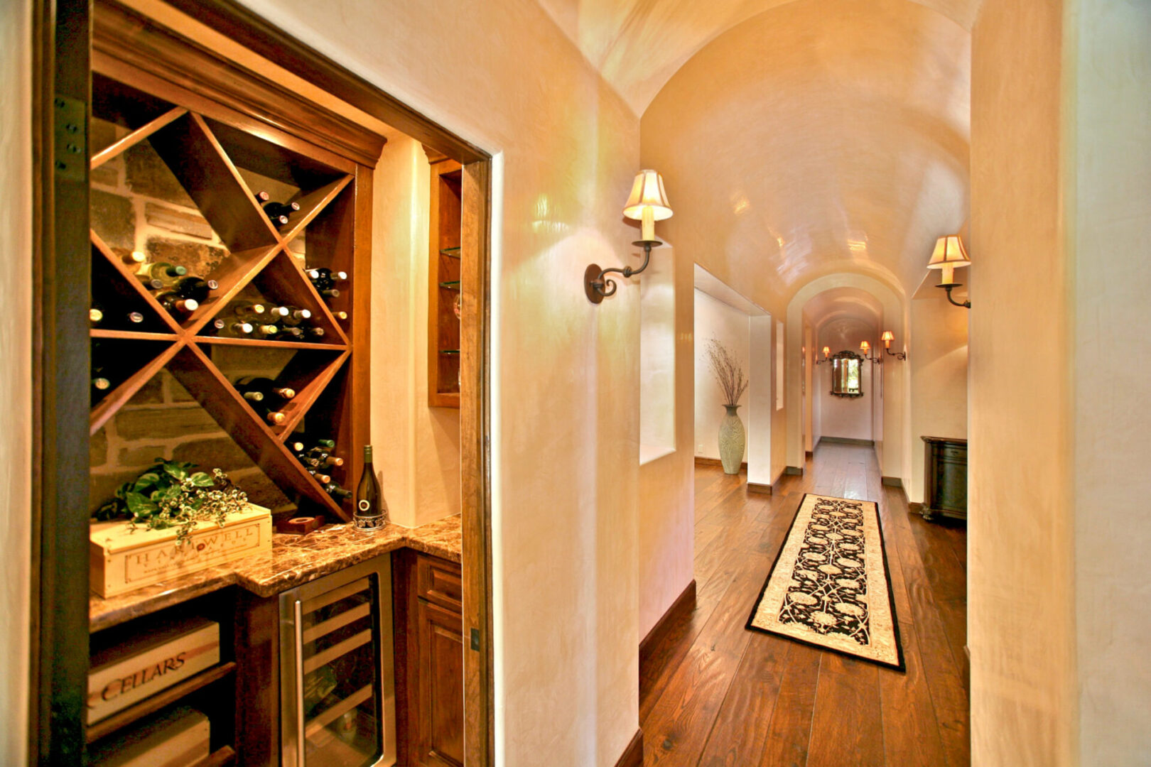 A wine cellar with a wooden floor and walls.