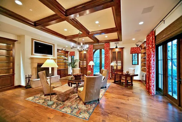 A living room with wood floors and red walls.